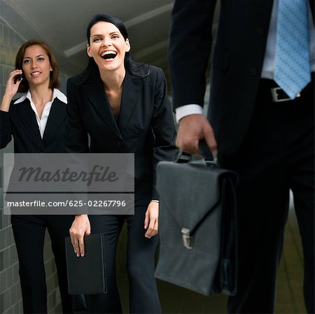 Business executives walking in a subway Business executives walking in a subway