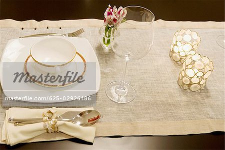 High angle view of a soup bowl with a wine glass on a dining table