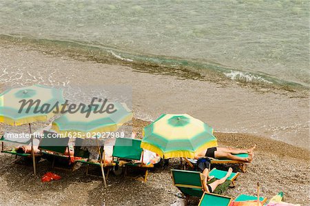 High angle view of tourists relaxing on lounge chairs, Spiaggia Grande, Positano, Amalfi Coast, Salerno, Campania, Italy