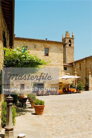 Sidewalk cafe beside a church, Romanesque Church, Piazza Roma, Monteriggioni, Siena Province, Tuscany, Italy