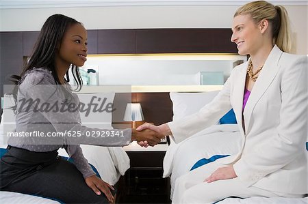 Two businesswomen shaking hands