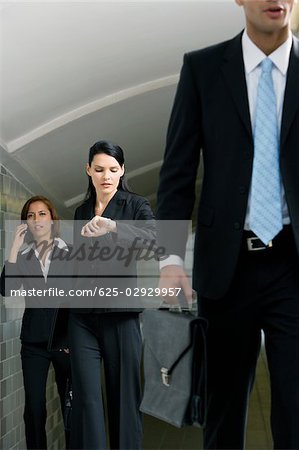 Business executives walking in a subway Business executives walking in a subway