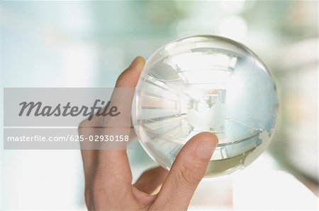 Close-up of a person's hand holding a globe