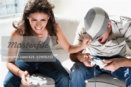 High angle view of a young couple playing video game