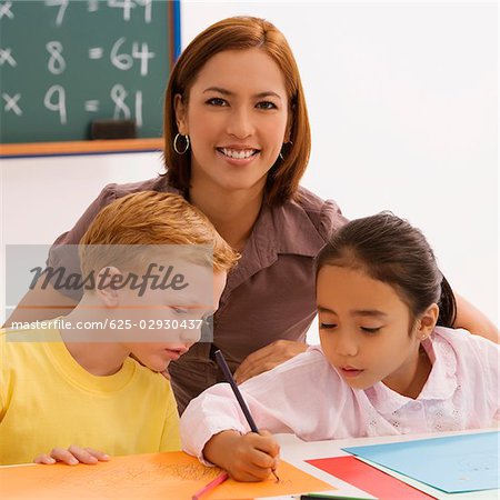 Female teacher teaching her two students