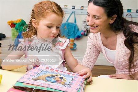 Female teacher teaching her student in a classroom