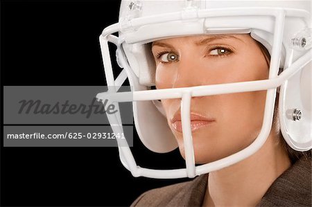Close-up of a businesswoman wearing a football helmet