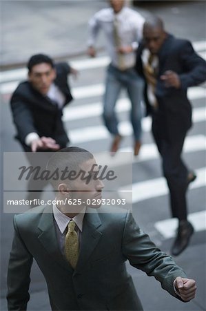 High angle view of business executives chasing a businessman