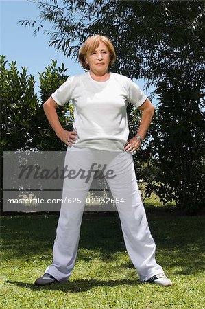 Senior woman exercising in a garden