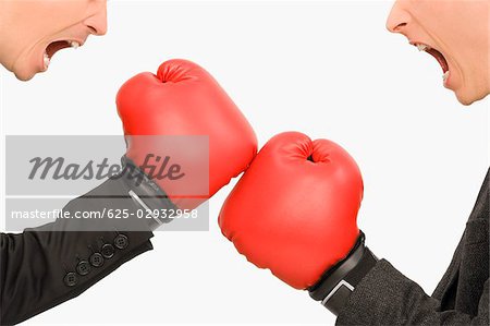 Side profile of two businessmen boxing