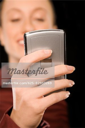 Businesswoman text messaging and smiling