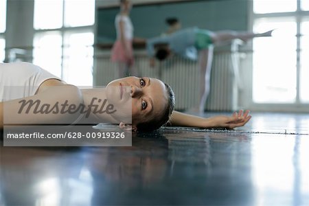 A female ballet dancer lying on the floor