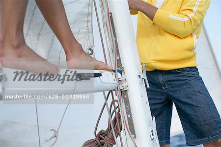Two men setting a sail