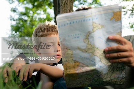 Father and son looking at a world map
