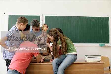 Teacher explaining human anatomy to pupils