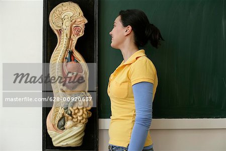 Teenage girl standing next to a human model