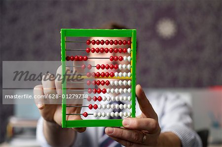 Businessman calculating with an abacus