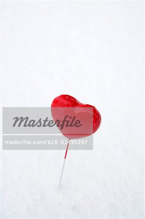 Heart-shaped lollipop in snow