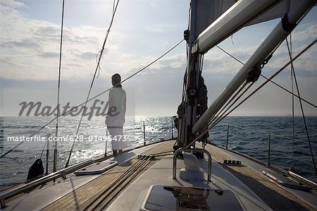 Woman standing on a sailing yacht