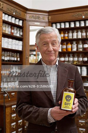 Man holding brown glass bottle with poison sign