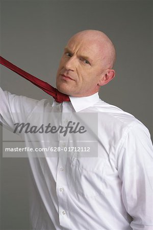 Businessman pulling his tie