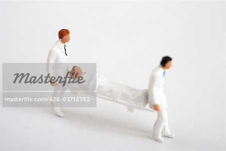 Figurines of doctors carrying a stretcher