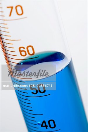 A test tube with measuring scale and blue liquid