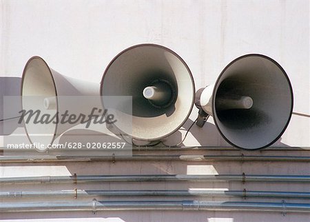 Three speakers mounted on a wall