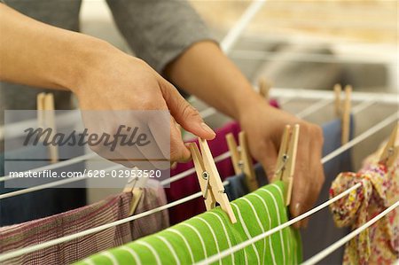 Woman hanging washing on clothes horse