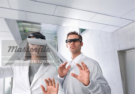 Woman and man with head-mounted displays