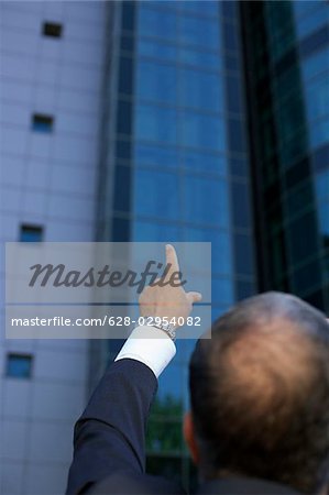 Person pointing at an office building