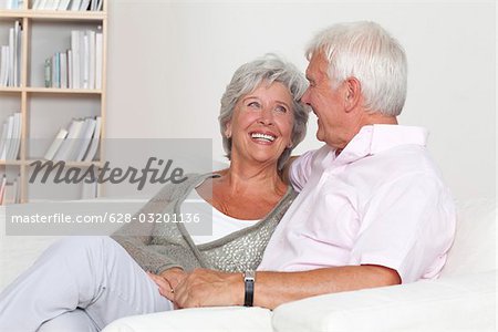 Happy senior couple on sofa