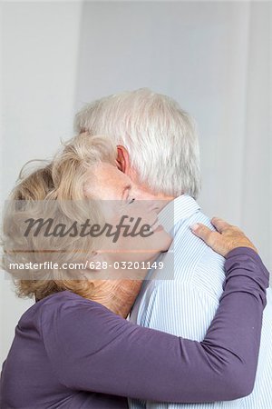 Happy senior couple hugging