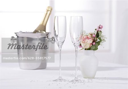 Two champagne glasses with ice bucket