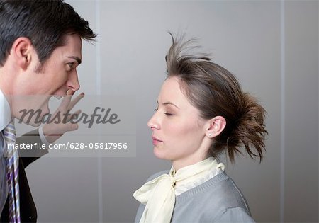 Businessman screaming at woman