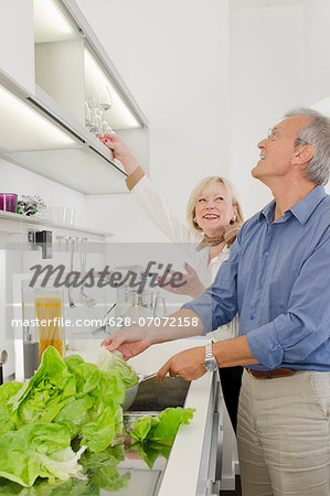 Senior couple preparing healthy meal in kitchen