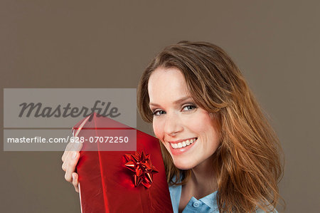 Happy young woman holding gift