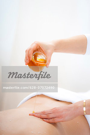 Masseuse Pouring Honey On Females Back Stock Photo Masterfile Premium Royalty Free Code 628 07072490