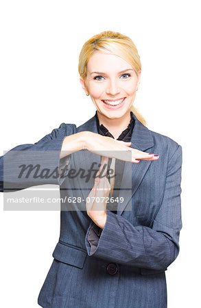 Smiling businesswoman making time out sign
