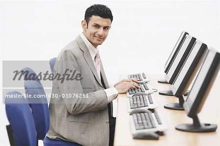 Portrait of a businessman sitting in front of a computer
