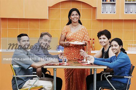 Portrait of a family sitting at the dining table