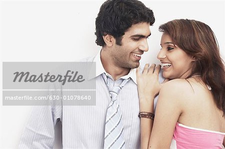 Businessman standing with a young woman leaning on him