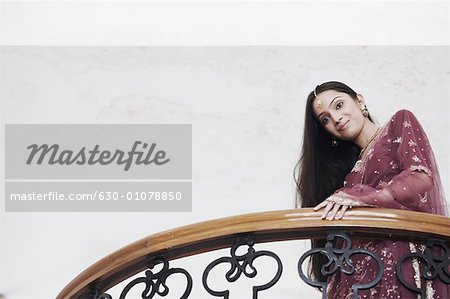 Low angle view of a teenage girl standing in a balcony