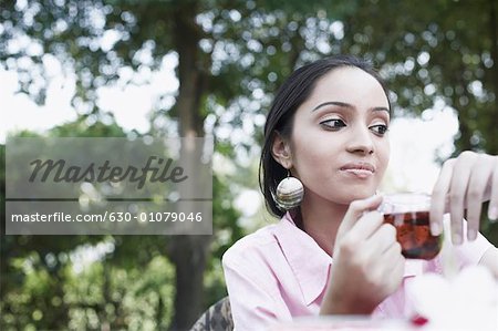 Low angle view of a teenage girl holding a cup of tea