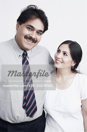 Close-up of a mature couple with arms around smiling