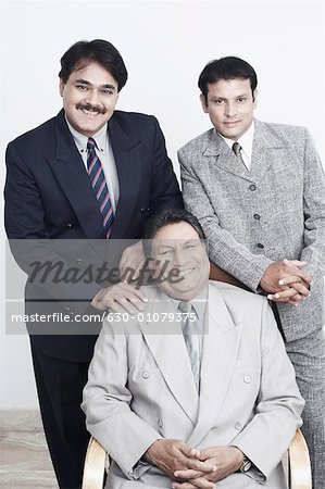 Portrait of a father and his two sons smiling