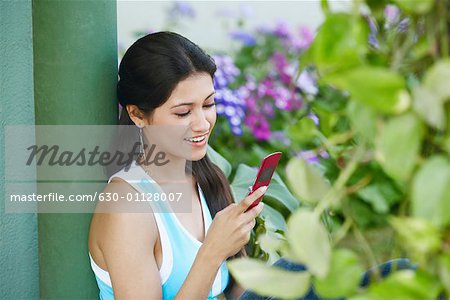 Side profile of a young woman holding a mobile phone