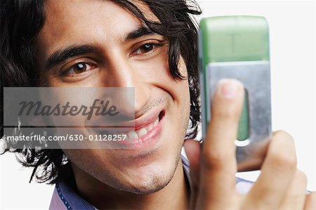 Close-up of a young man looking at a mobile phone