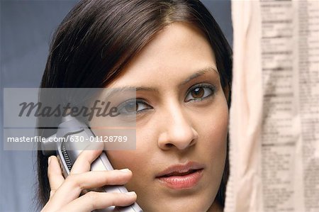 Close-up of a businesswoman talking on a cordless phone