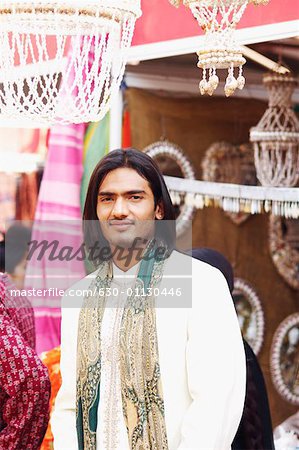 Portrait of a young man standing in a market